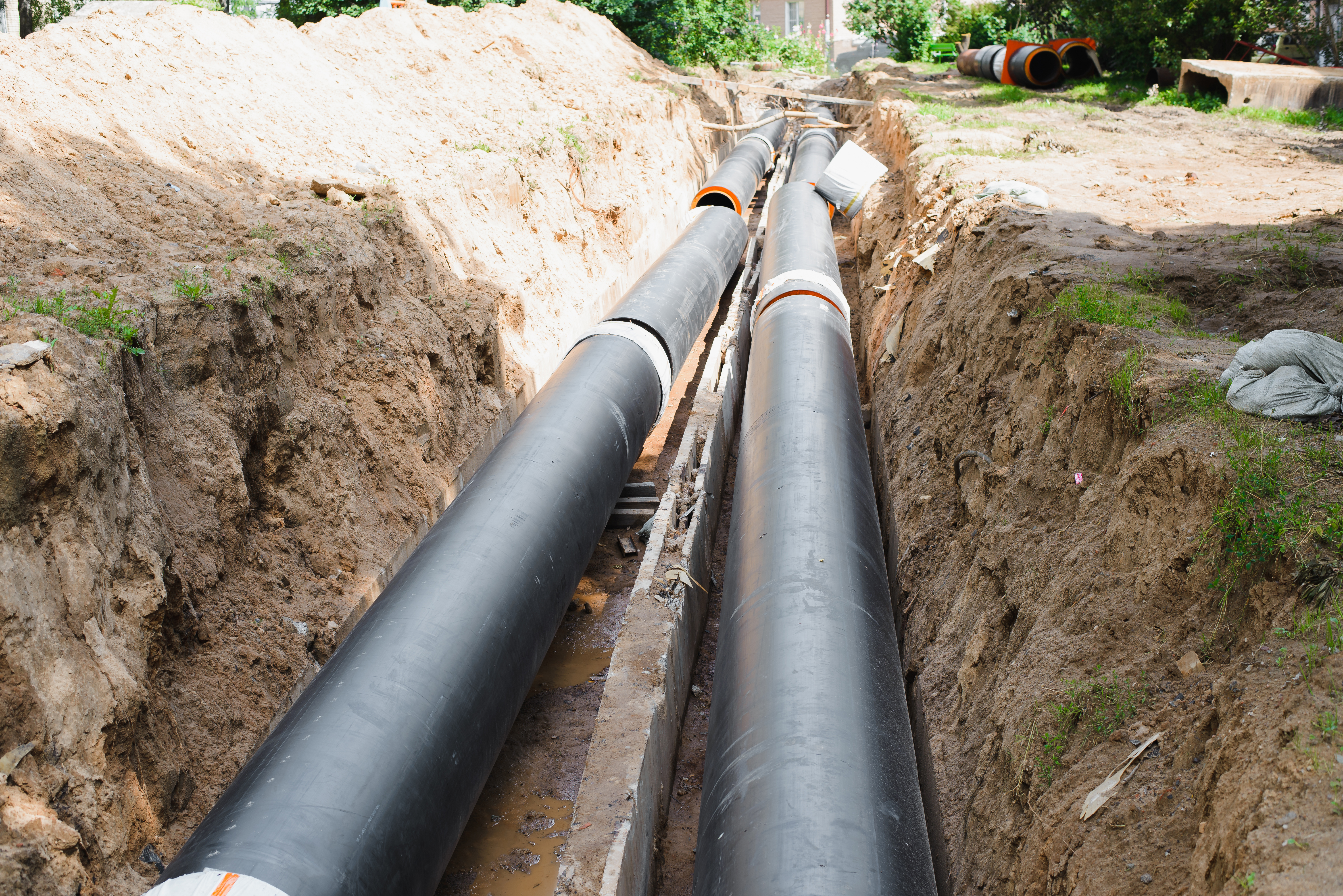 New industrial pipe installation replacing existing underground water supply line